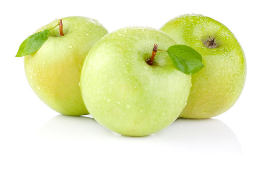 Three apples with green leaves and water drops on a white backgr