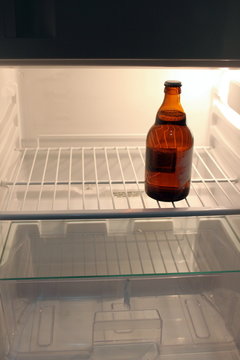 Last Beer Bottle In An Empty Fridge