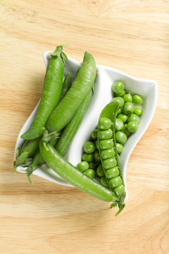 Fresh green peas on the white bowl