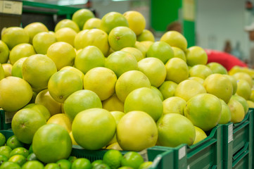 Bunch of green Pomelo in boxes in supermarket