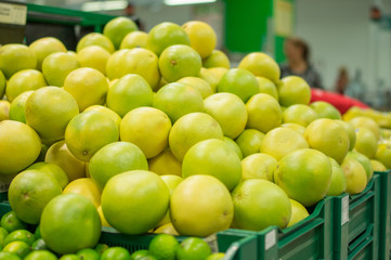 Bunch of green Pomelo in boxes in supermarket