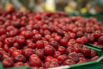 Bunch of red plum in boxes in supermarket