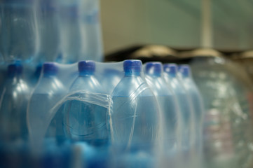 Bottles with fresh water on shelves in supermarket