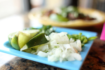 Lime, onions, and cilantro in a dish as a side for tacos.