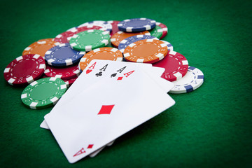 poker, four aces over a background with casino chips