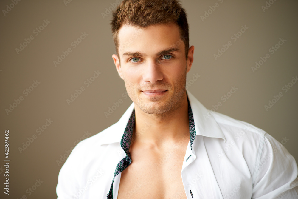 Wall mural close up of sporty man posing in white shirt