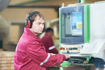 Portrait of carpentry worker with CNC machine
