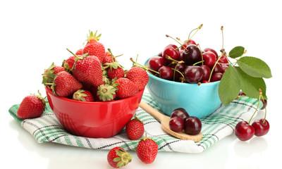 Ripe strawberries and cherry berries in bowls isolated on white