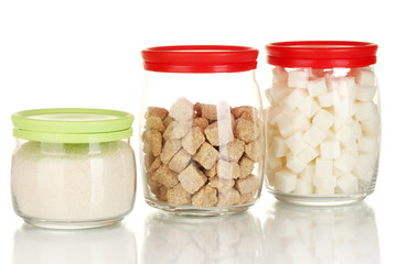 Jars with brown cane sugar lump, white crystal sugar and white