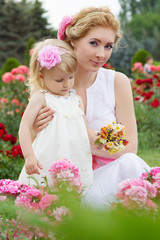 Mother and baby in rose garden