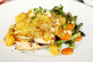 Charbroiled chicken breast with pineapple macadamia nut chutney.