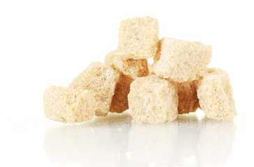 brown cane sugar cubes isolated on white