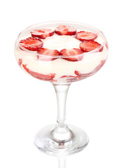 Glass of ripe strawberries with cream isolated on white