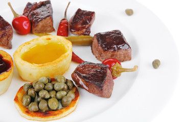 food: grilled meat goulash on white plate