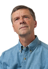 Senior man in blue shirt looks pensive