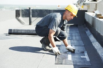 Flat roof covering works with roofing felt - obrazy, fototapety, plakaty