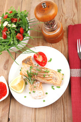  grilled pink salmon steaks with red caviar in white bowl