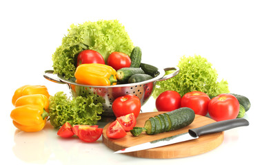 fresh vegetables and knife on cutting board isolated on white