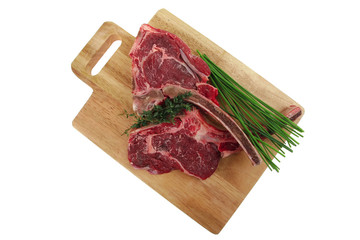 raw pork with thyme and green chives on wooden board