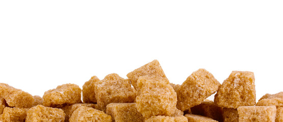 Lump brown cane sugar cubes isolated on white