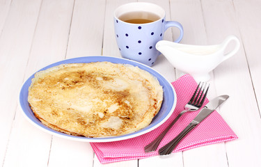 Stack of tasty pancakes on wooden background