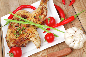 chicken quarters garnished with red hot peppers