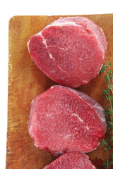 red fresh fillet chops : three raw beef fillet chops