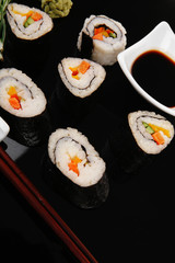 Different types of maki rolls on black