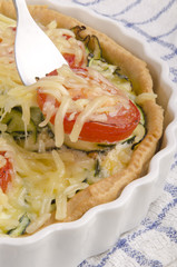 freshly made zucchini quiche with tomato
