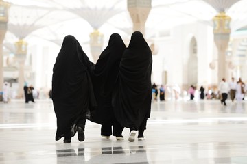 Three Moslim women walking outdoors