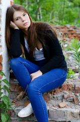 Sexy Lady Leaning against an Old Stone Wall