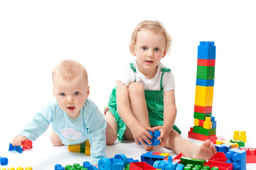 baby with block on the white floor