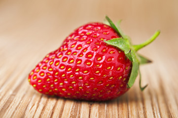 Fresh red strawberries on wooden table