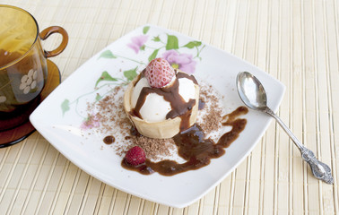 Dessert a cream ice-cream with a fresh strawberry