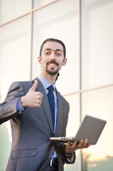 Fototapeta premium Young businessman on the street