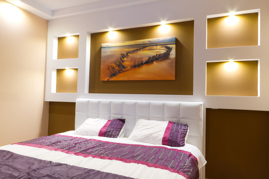 Modern master bedroom interior with picture of shipwreck