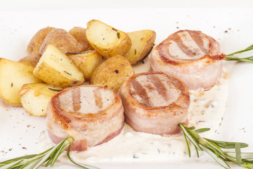 Grilled steak wrapped in bacon, with grilled vegetables, mashed