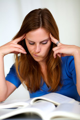 Beautiful tired girl studying