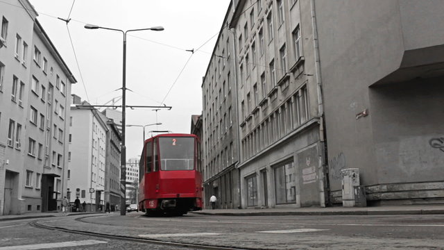 Red tram in the bw city.