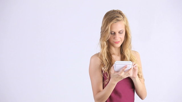 smiling blonde girl uses a calculator