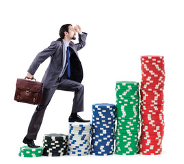 Businessman climbing stacks of casino chips