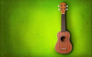 Obraz premium Ukulele on green background