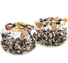 Cake with nuts and whipped cream on a white background..