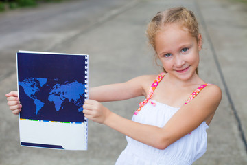 child, holding a book with a map