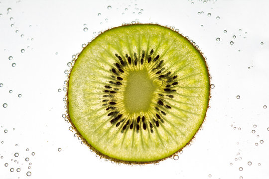 Kiwi fruit floating in soda water