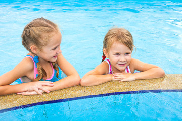 two little girls playing in the pool
