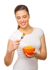 Happy young woman with fruit salad