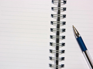 Notebook and pencil on a white background.