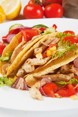 Grilled chicken and salad in taco shells