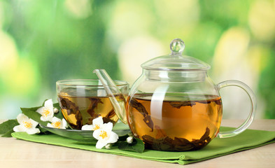 green tea with jasmine in cup and teapot